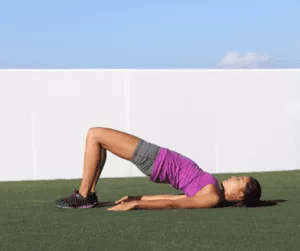 a woman doing a variation of plank outdoor